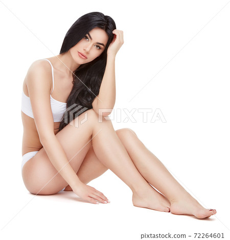 Fitness young woman with a beautiful body sitting on white background 72264601