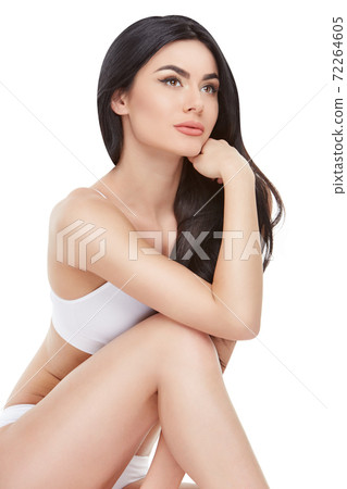 Fitness young woman with a beautiful body sitting on white background 72264605