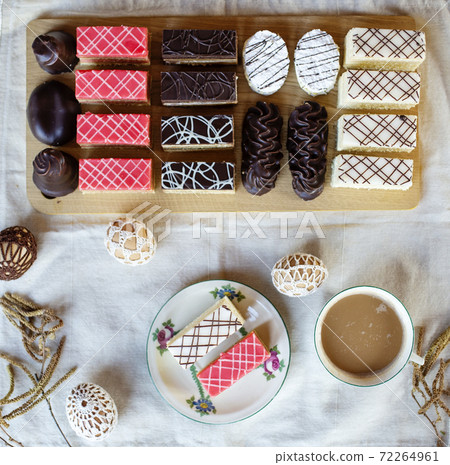 Top view of selection of colorful and delicious cake desserts on tray on table. 72264961