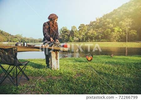 Natural tourist woman, she is doing breakfast, eating food. Travel camping, Travel camping by lake. Campers are on their camp at Namtok Sam Lan National Park (waterfall) 72266799