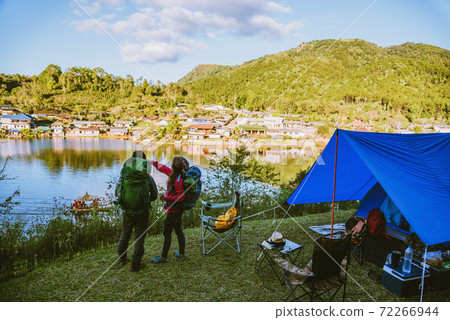 Asian couple Mountain camps in rural villages, close to the lake, travel ideas, camping, relaxing holidays.in Thailand Asian couple Mountain camps in rural villages, close to the lake, travel ideas, camping, relaxing holidays.in Thailand 72266944