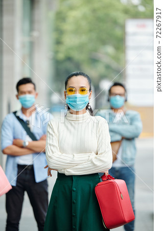 Serious young Asian woman in mask Serious young Asian woman in mask 72267917