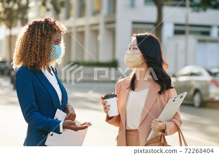 Businesswomen discussing project Businesswomen discussing project 72268404