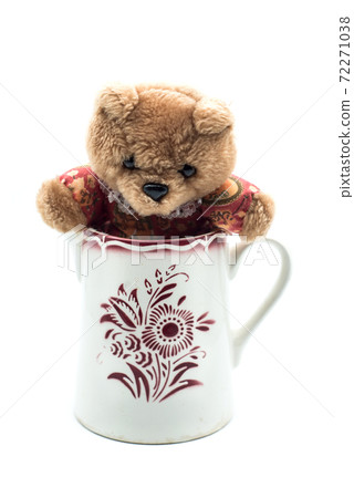 Closeup of traditional teddy bear in a retro ceramic pot on white background Closeup of traditional teddy bear in a retro ceramic pot on white background 72271038
