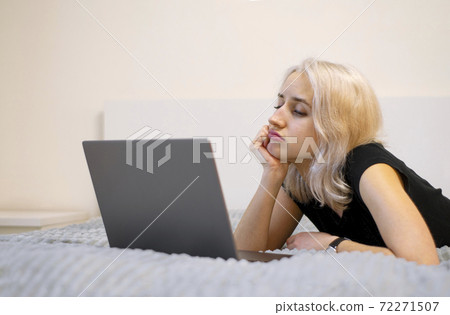 The girl is watching a TV series on a laptop. The girl is watching a TV series on a laptop. 72271507