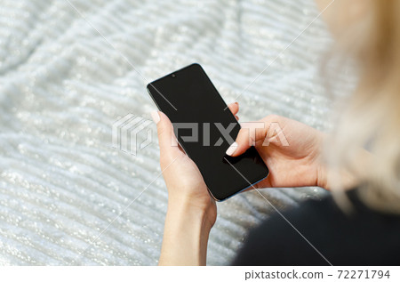A young girl is using her mobile phone. Communication at a distance. 72271794