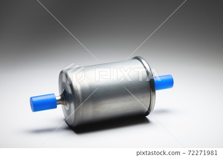 New fuel filter for gasoline internal combustion engine with blue caps on a gray background. New spare parts New fuel filter for gasoline internal combustion engine with blue caps on a gray background. New spare parts 72271981