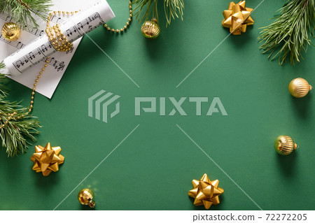 Music frame for Christmas Carols and sings decorated golden balls on green. Music frame for Christmas Carols and sings decorated golden balls on green. 72272205