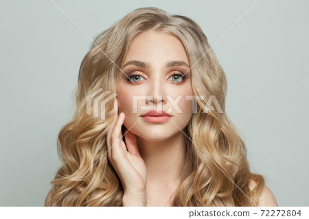 Cute young woman with healthy curly hair close up on white Cute young woman with healthy curly hair close up on white 72272804