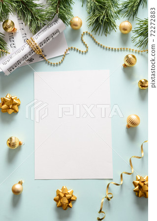 Empty blank for Christmas Carols and sings decorated golden balls on blue background. 72272883