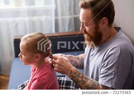 Father combing girl hair with hairbrush Father combing girl hair with hairbrush 72273363