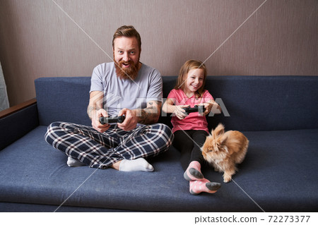 Dad and preschooler daughter sitting on couch Dad and preschooler daughter sitting on couch 72273377