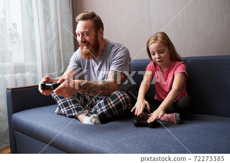 Father and small girl child having fun engaged in family activity Father and small girl child having fun engaged in family activity 72273385