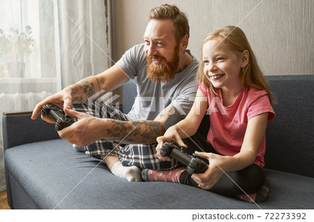 Father and his little blonde daughter wearing pajamas Father and his little blonde daughter wearing pajamas 72273392