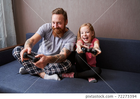 Dad enjoying video game with his cute amazing daughter Dad enjoying video game with his cute amazing daughter 72273394