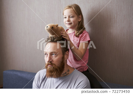 Girl holding her soft toy capybara Girl holding her soft toy capybara 72273450