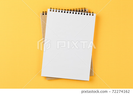 notebook on corrugated yellow background top view 72274162