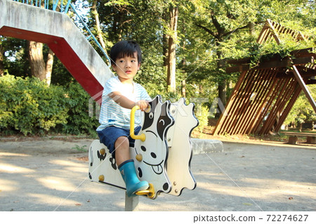 A boy playing in a park 72274627