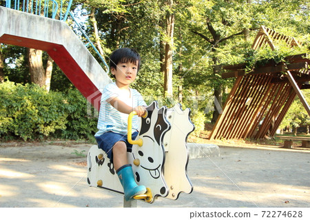 A boy playing in a park 72274628