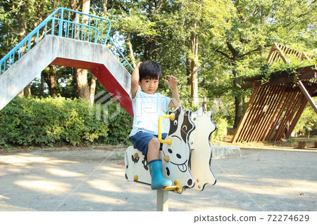 A boy playing in a park 72274629