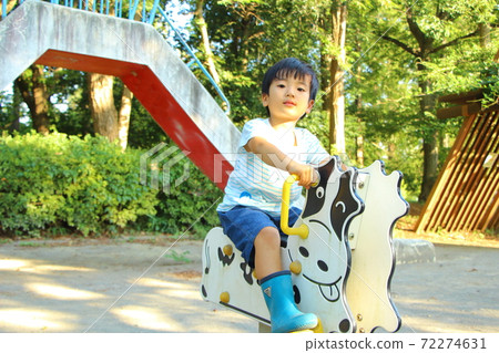 A boy playing in a park 72274631