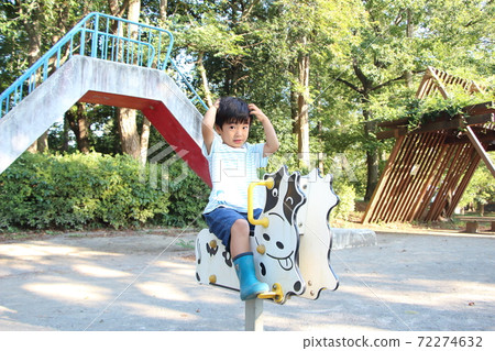 A boy playing in a park 72274632