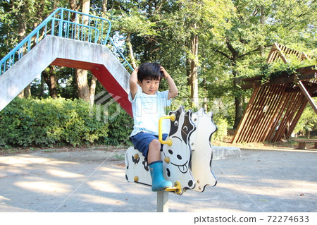 A boy playing in a park 72274633