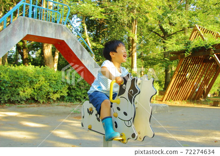 A boy playing in a park 72274634