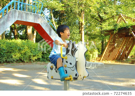 A boy playing in a park 72274635