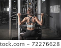 young fitness woman workout with exercise-machine in gym 72276628