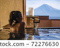Beautiful woman enjoy onsen (mineral hot bath) in morning and seeing view of Fuji mountain in japan 72276630