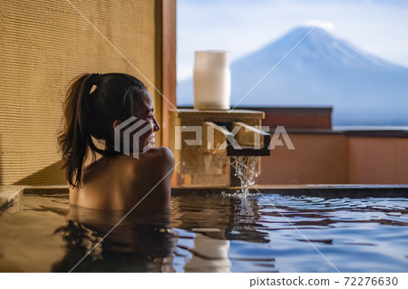 Beautiful woman enjoy onsen (mineral hot bath) in morning and seeing view of Fuji mountain in japan Beautiful woman enjoy onsen (mineral hot bath) in morning and seeing view of Fuji mountain in japan 72276630