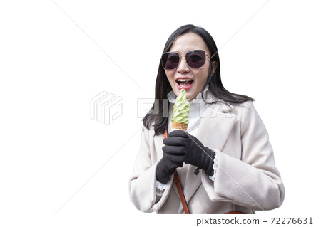 Young woman eating ice cream cone on white background Young woman eating ice cream cone on white background 72276631