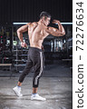 bodybuilder workout in fitness gym. 72276634