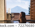 Beautiful woman enjoy onsen (mineral hot bath) in morning and seeing view of Fuji mountain in japan 72276680