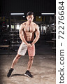 bodybuilder workout in fitness gym. 72276684