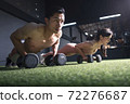 Strong fitness man and woman doing arm workout with dumbbells in the gym 72276687