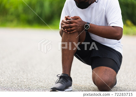 sport runner black man wear watch sitting hands joint hold knee 72283715