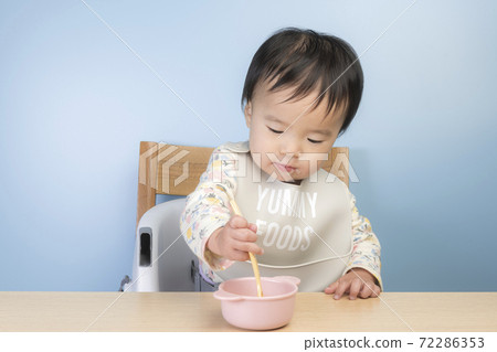 Baby eating baby food Baby eating baby food 72286353