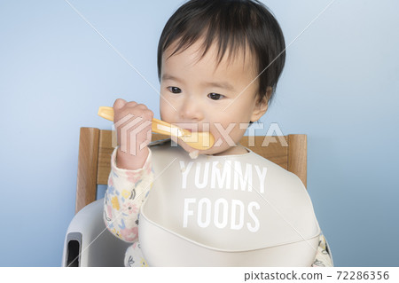 Baby eating baby food Baby eating baby food 72286356