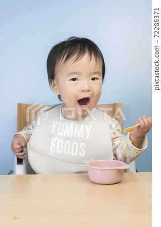 Baby eating baby food Baby eating baby food 72286371