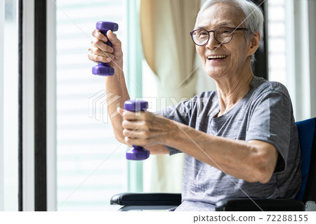 Strong asian senior woman working out with heavy dumbbells,lifting dumbbell weights for strength training,fitness elderly people doing exercise while sit in wheelchair,health care,healthy lifestyle 72288155