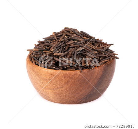Wild black rice in wooden bowl, isolated on white background. Wild black rice in wooden bowl, isolated on white background. 72289013