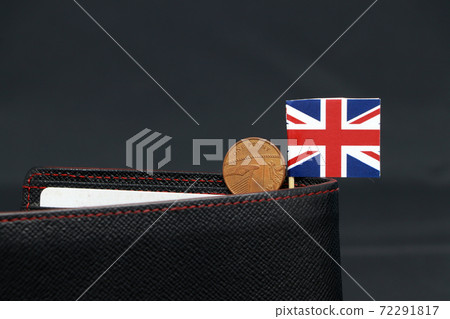 One Penny British decimal coin money and mini Union Jack flag stick on the black wallet One Penny British decimal coin money and mini Union Jack flag stick on the black wallet 72291817