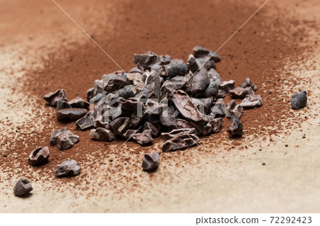 Cocoa nibs on baking paper close-up Cocoa nibs on baking paper close-up 72292423