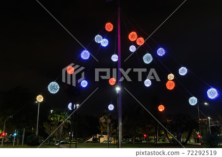 Night view of colourful Christmas balls decorations at a city square. 72292519