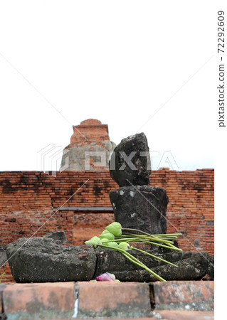 Incomplete of ancient stone Buddha with lotus flower on the lap in the ruins and ancient remains 72292609