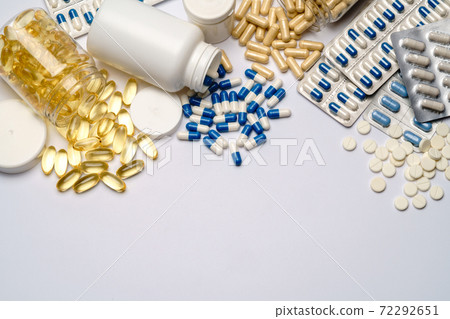 Medications capsules in plastic bottles on light grey background Medications capsules in plastic bottles on light grey background 72292651