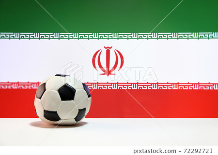 Small football on the white floor and Iranian nation flag background. The concept of sport Small football on the white floor and Iranian nation flag background. The concept of sport 72292721