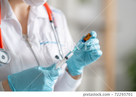 doctor holding injection vaccine. doctor holding injection vaccine. 72293701